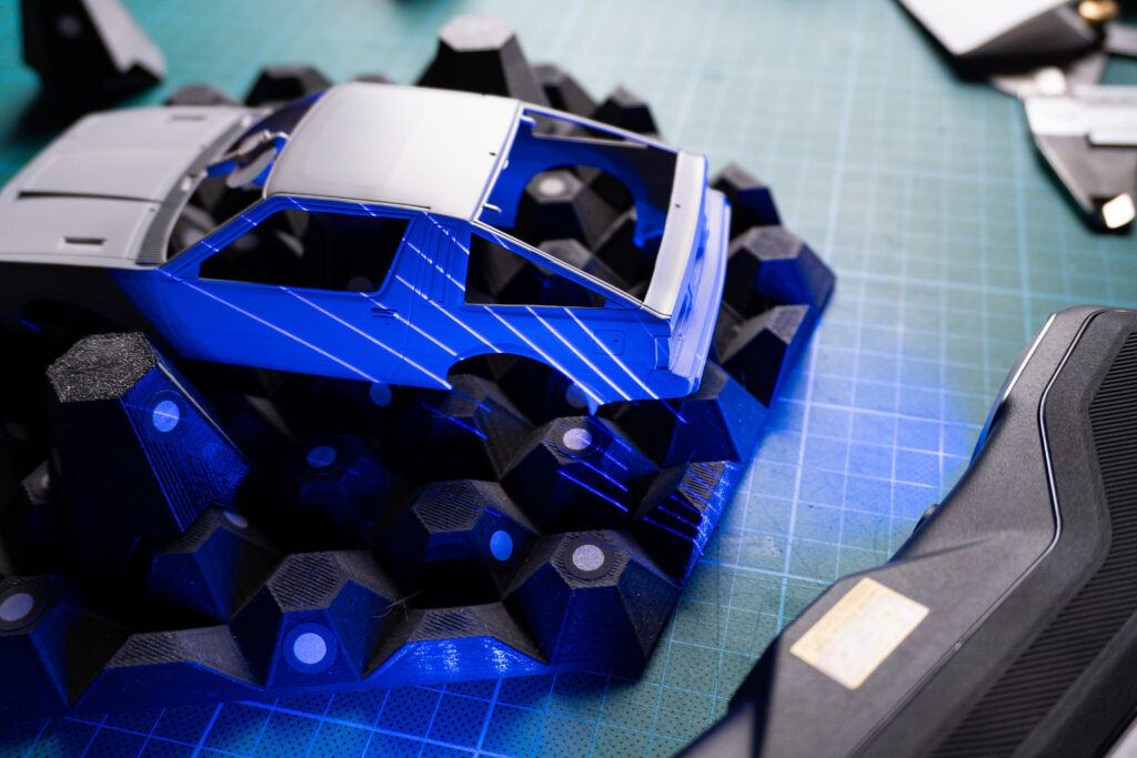 An image of the model kit bodywork on a scanning background, being scanned.